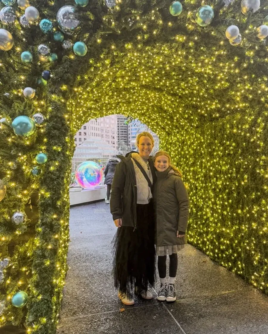 Original photo of a mom and daughter under holiday lighting