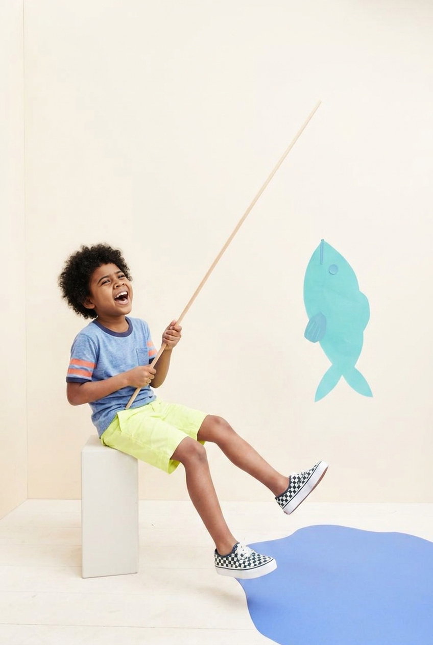 Noah pretending to fish for a paper fish